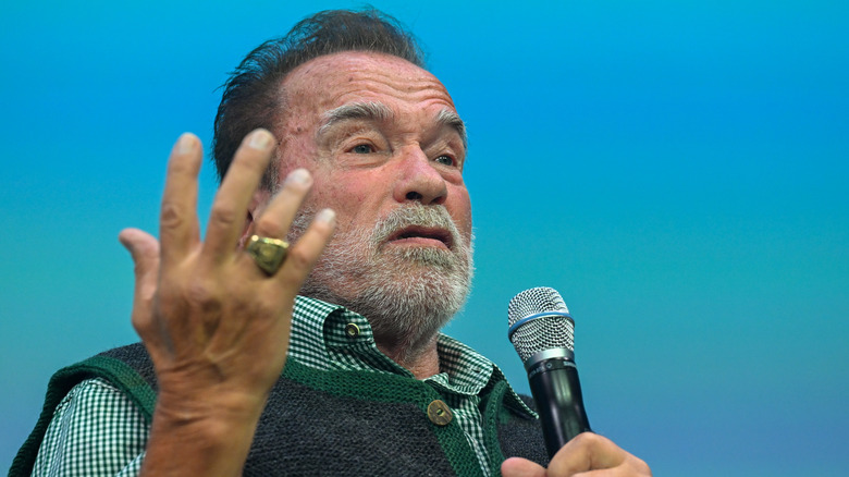 Arnold Schwarzenegger holding microphone