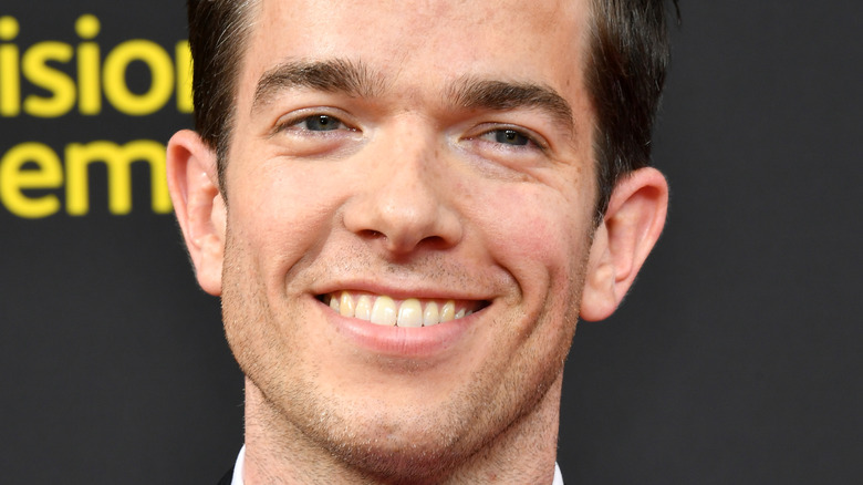 John Mulaney smiling for photo