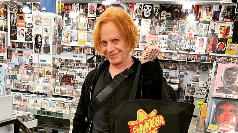 Danny Elfman stands in a record shop
