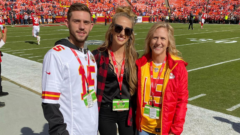 Brittany Mahomes posing with brother, mom