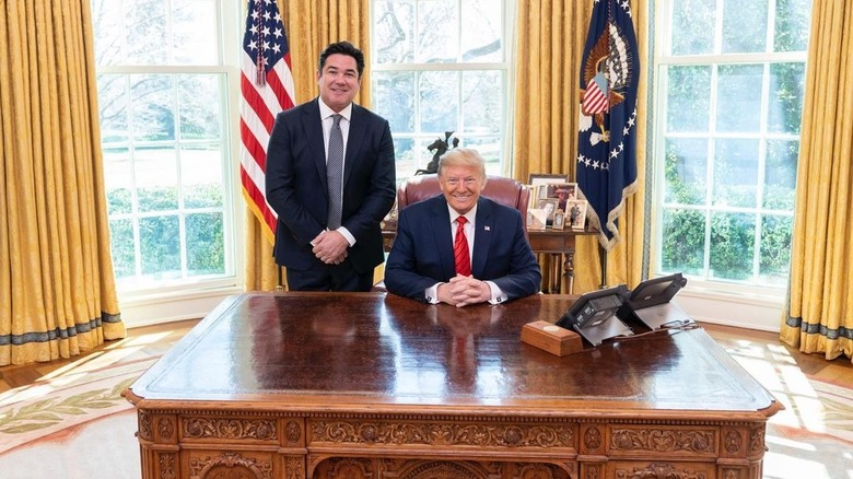 Dean Cain poses next to Donald Trump in the Oval Office
