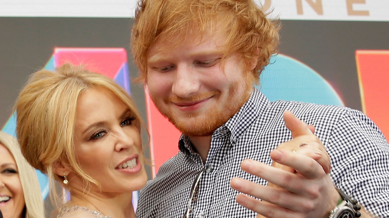 Kylie Minogue and Ed Sheeran holding hands