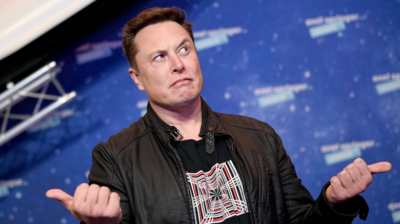 Elon Musk holding thumbs up
