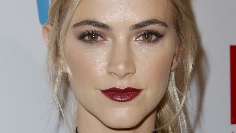 Emily Wickersham posing on the red carpet