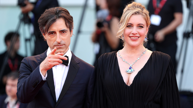 Greta Gerwig smiling with Noah Baumbach pointing