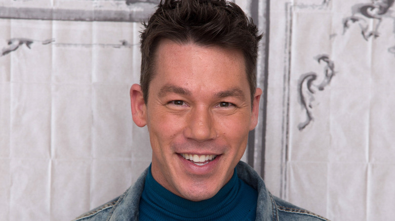 David Bromstad in blue turtleneck, denim jacket