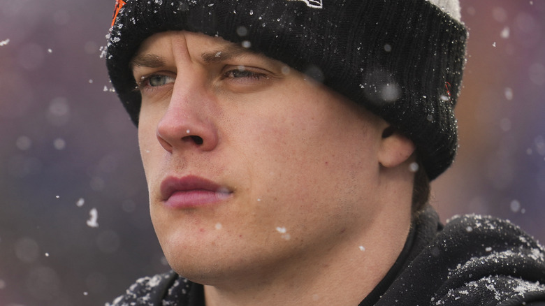 Joe Burrow watches a playoff game