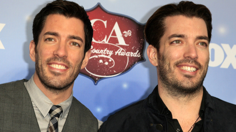 The Property Brothers pose together in 2013