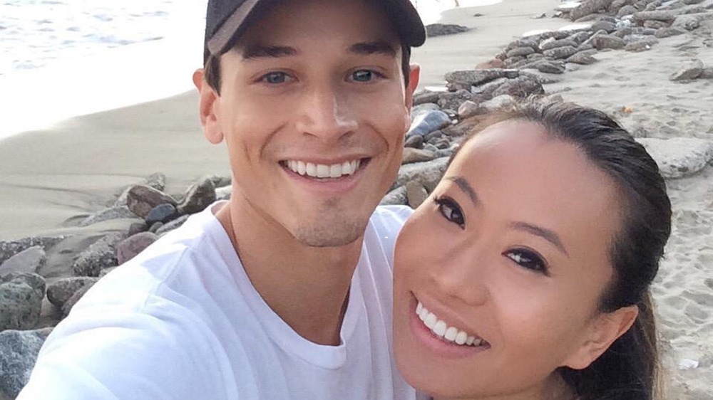 Andrew Gray and Kelly Mi Li take a selfie on the beach