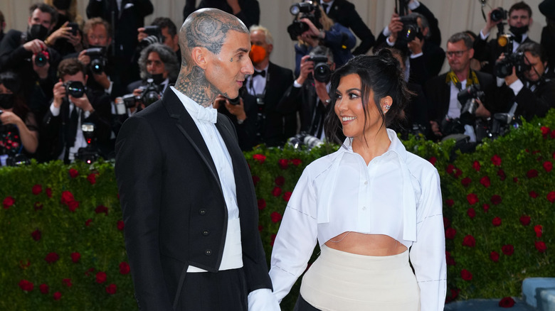 Travis Barker and Kourtney Kardashian smiling