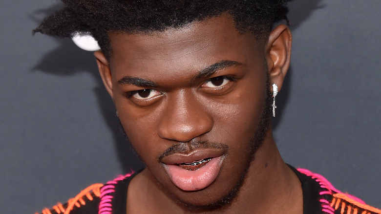 Lil Nas X smiling looking up