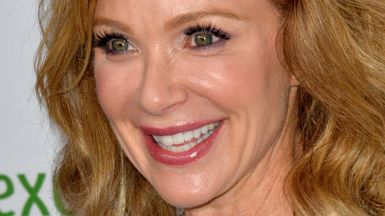 Lauren Holly smiles and looks off-camera during a red carpet event