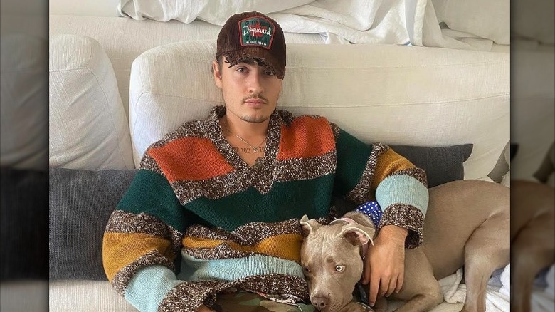 Brandon Thomas Lee on couch with dog