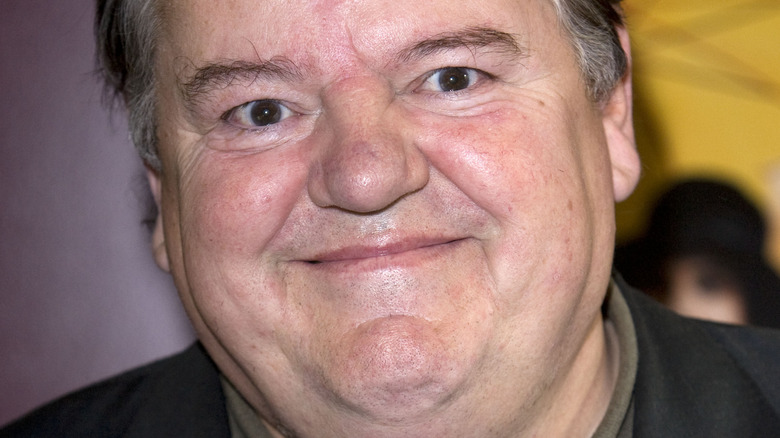 Robbie Coltrane smiling for photo