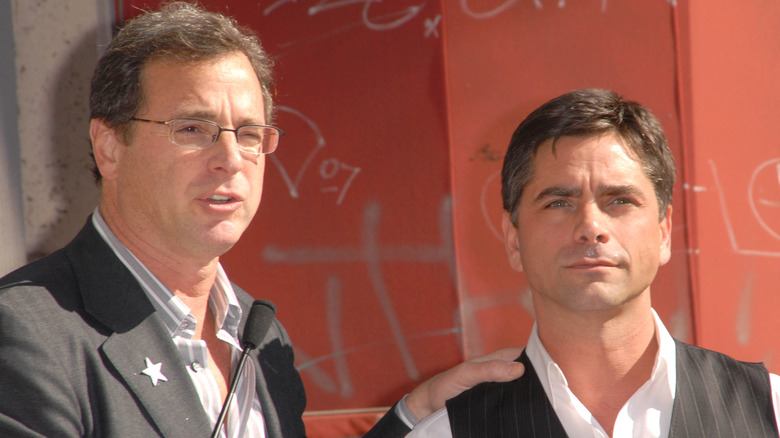 Bob Saget and John Stamos giving a speech