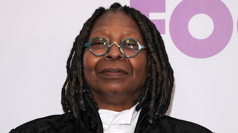 Whoopi Goldberg wearing green glasses