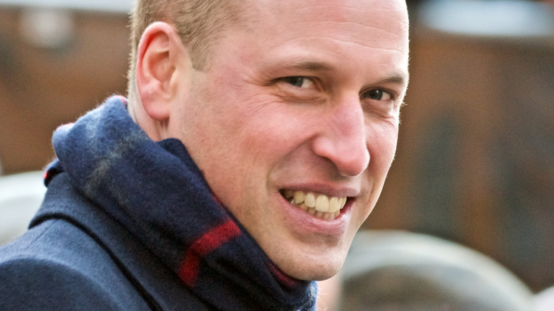 Smiling Prince William wearing scarf