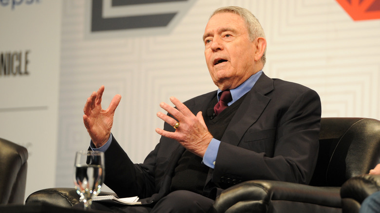 Dan Rather speaks, sitting