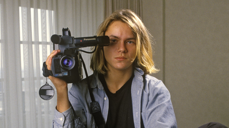 River Phoenix holding a video camera
