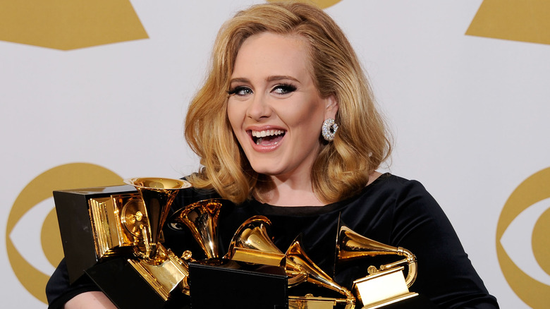 Adele holding Grammy awards
