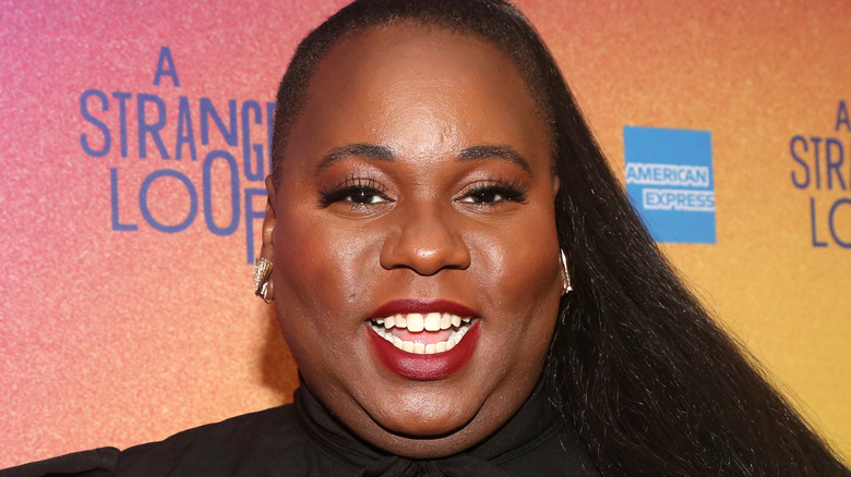 Alex Newell smiling at event