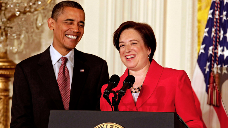 barack obama and elena kagan smiling at a podium