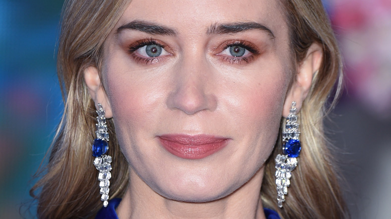 Emily Blunt in a blue dress, long diamond earrings
