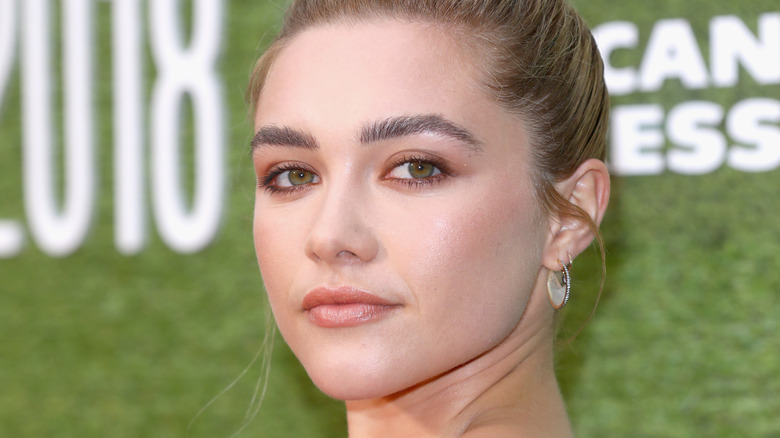 Florence Pugh with her hair in a bun