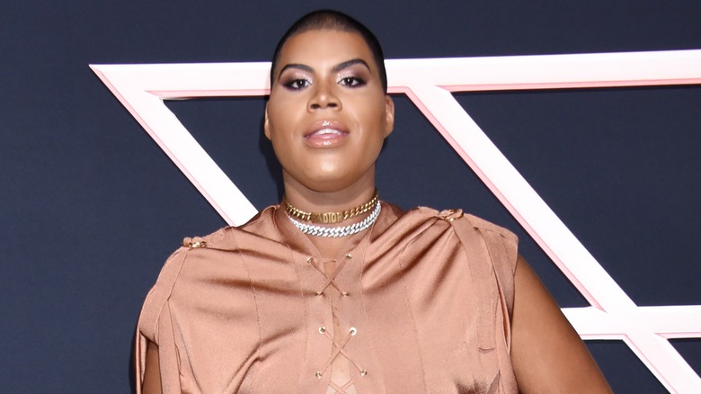 EJ Johnson wearing a blush dress