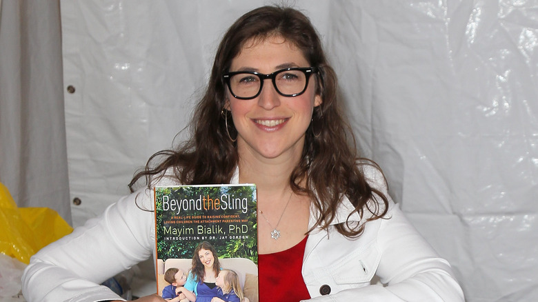 Mayim Bialik posing with her book
