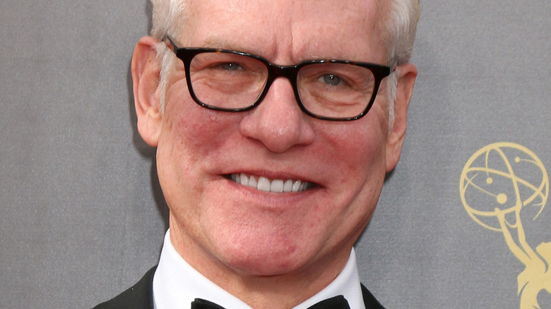 Tim Gunn smiling and wearing glasses at the Emmy Awards