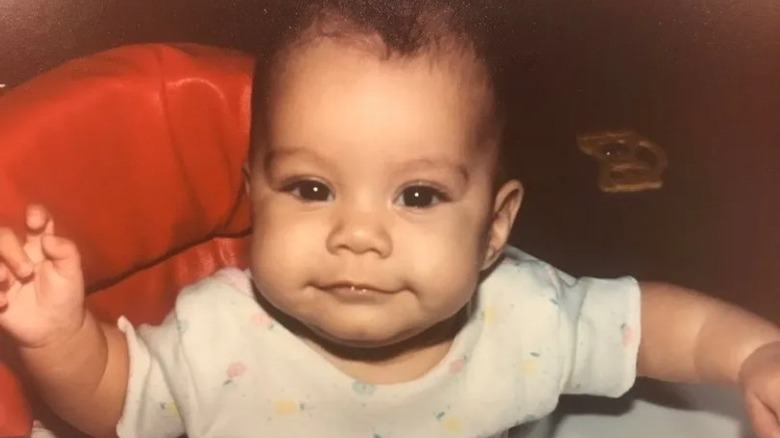 Baby Vanessa Hudgens smiles at camera