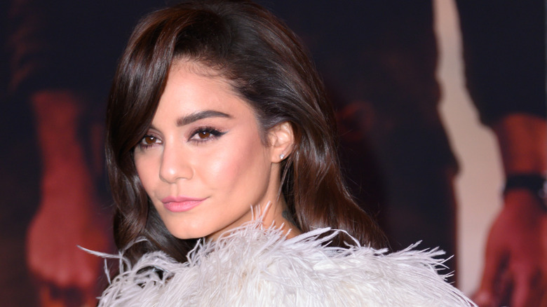 Vanessa Hudgens in feathery top, looking on