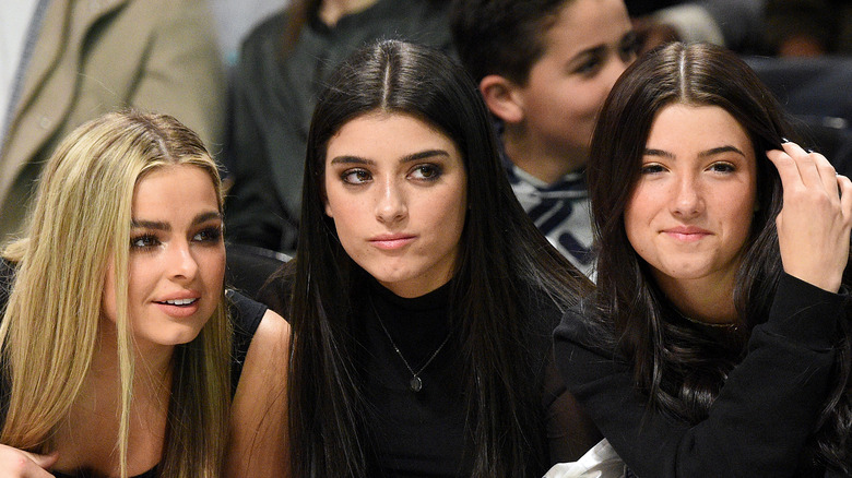 Addison Rae, Dixie and Charli D'Amelio, all seated and looking