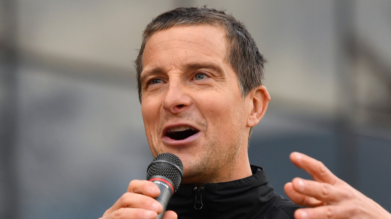 Bear Grylls with microphone in hand