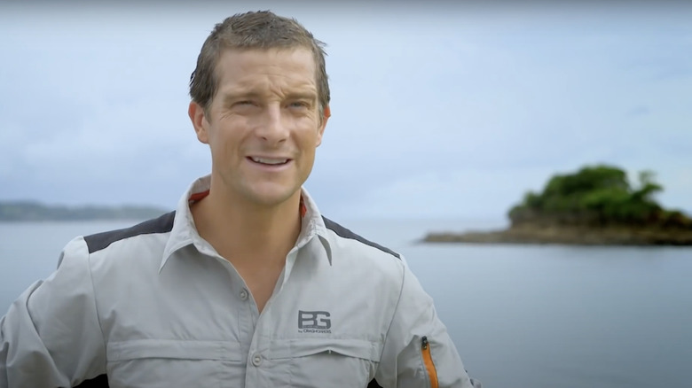 Bear Grylls outside by the water