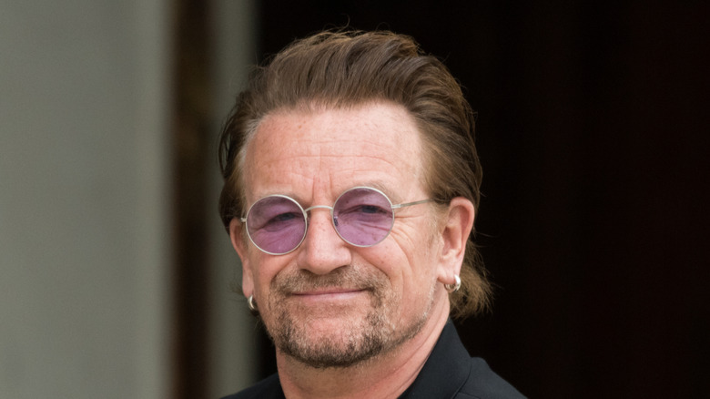 Bono posing with a slight smirk