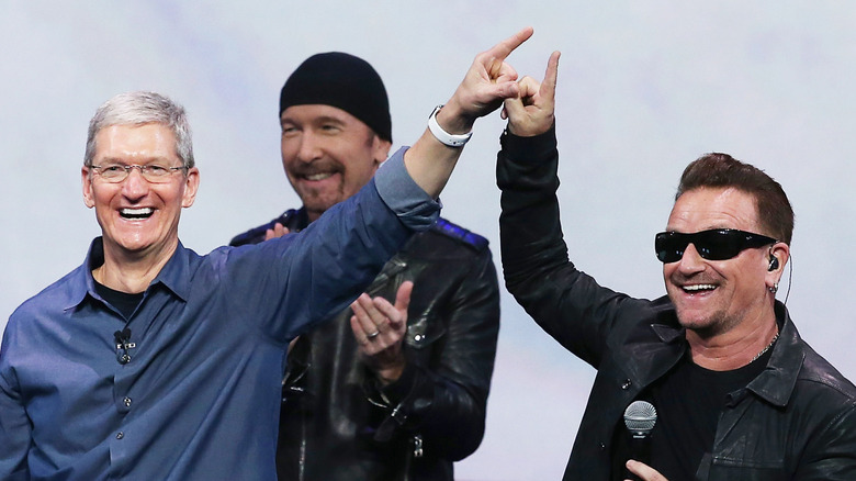 Tim Cook, The Edge, and Bono onstage