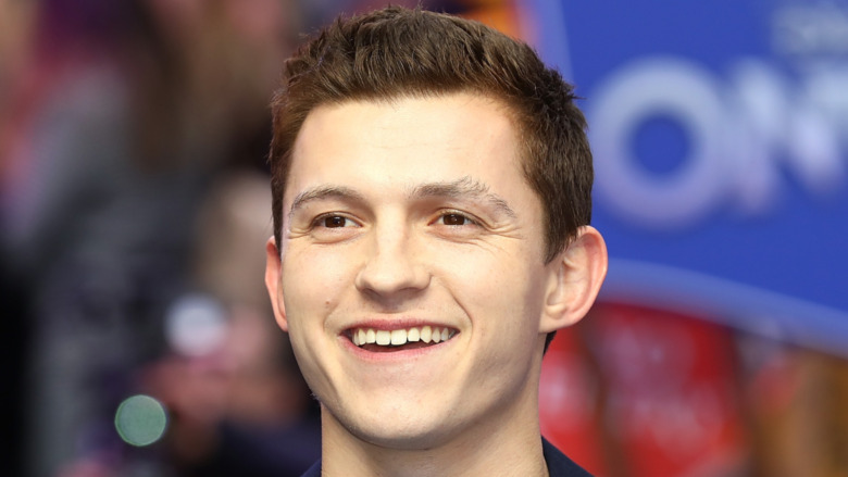 Tom Holland smiling big at the Onward UK premiere