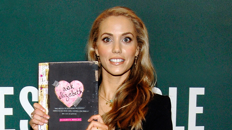 Elizabeth Berkley holding her book