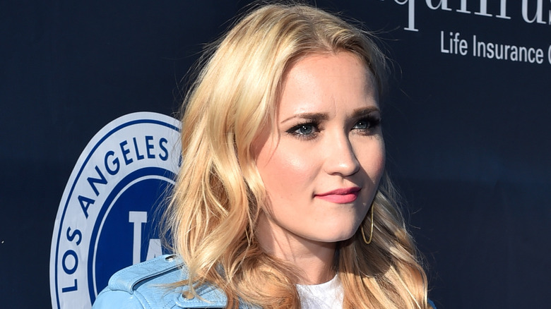 Emily Osment looks on
