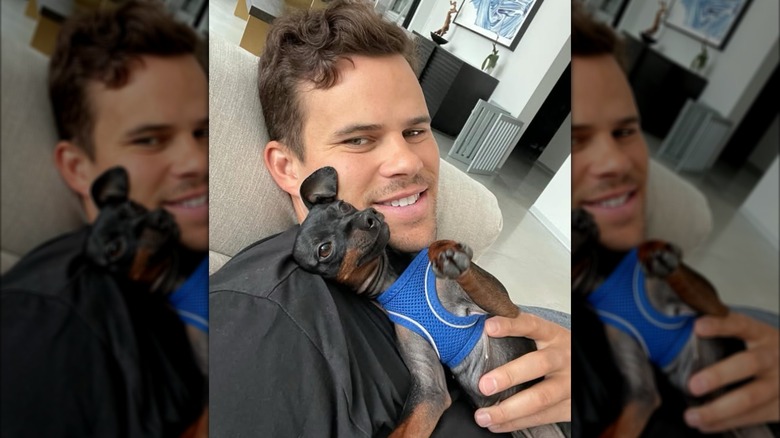 Kris Humphries posing with his dog Riccardo.