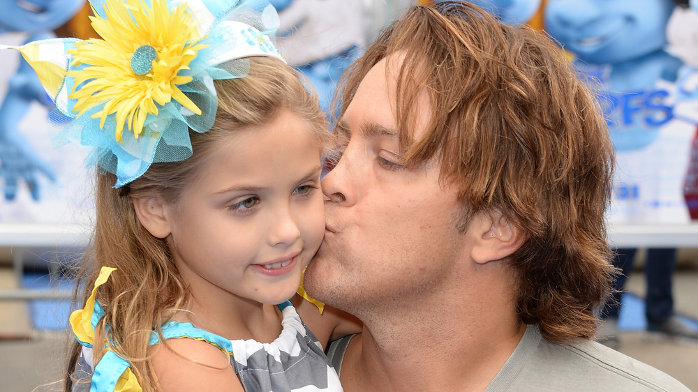 Dannielynn Birkhead getting a kiss from dad Larry Birkhead