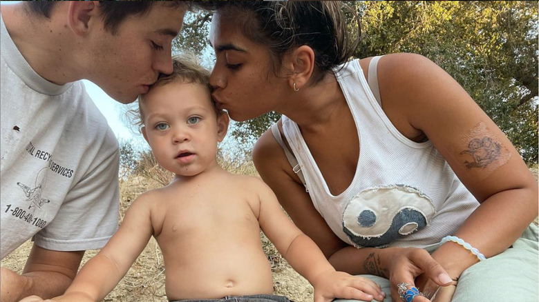 Nash Grier kissing his son with fiancé Taylor Giavasis