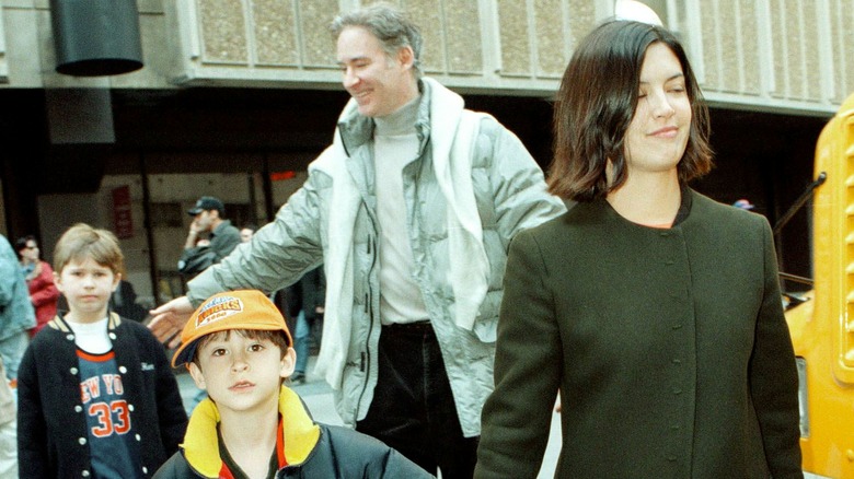 Phoebe Cates walking with her son