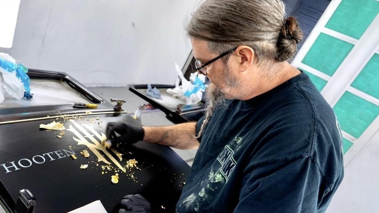 Ryan Evans painting a logo