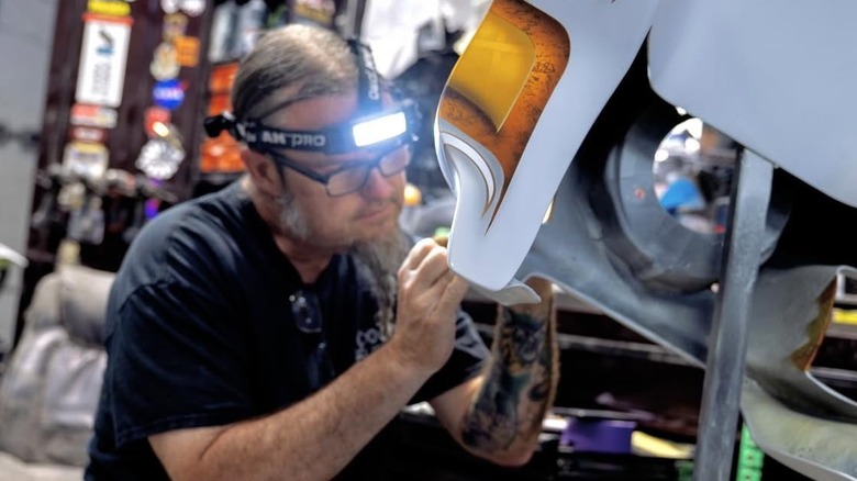 Ryan Evans painting a motorcycle