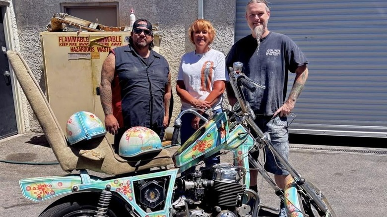 Ryan Evans posing with a painted motorcycle