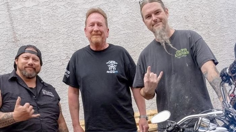 Ryan Evans posing with a finished motorcycle