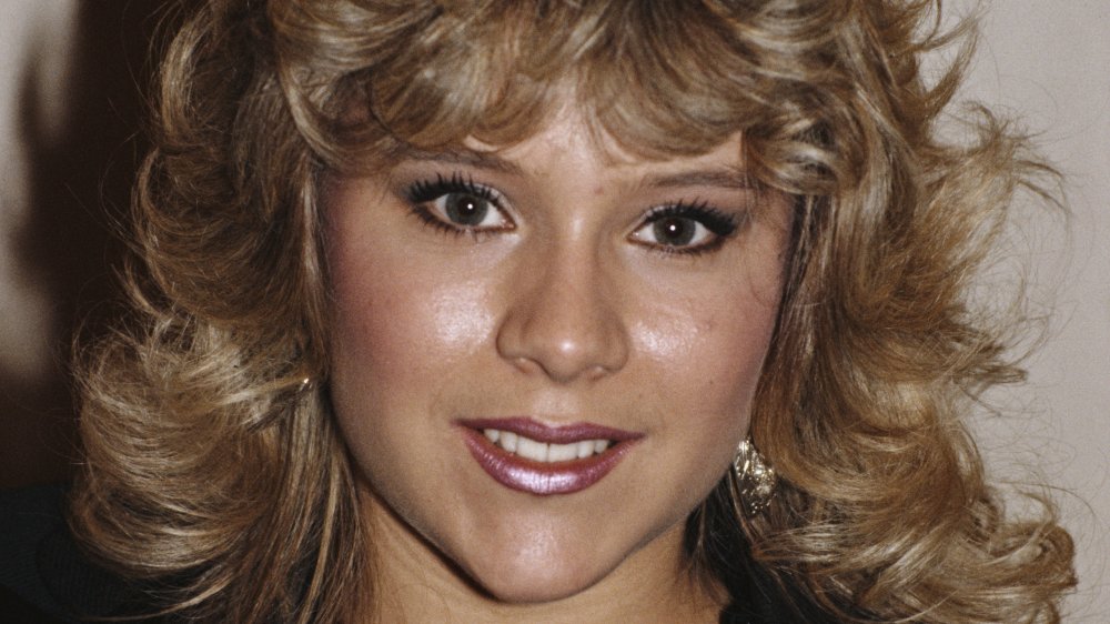 Samantha Fox in a black leather jacket, smiling at an awards show in 1986